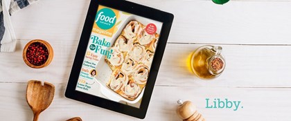 The word "Libby" with a tablet showing Food Network magazine with oil bottle, wooden spoon, salt grinder, bowl of berries, and dish towel.